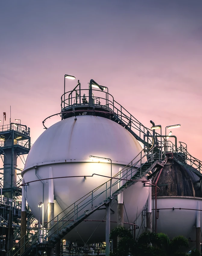 Wieczór w fabryce inżynieryjnej z zbiornikami i maszynami w świetle zmierzchu. Stalowe rury i sprzęt przemysłowy w ustawieniu przemysłowym napędzanym nauką.